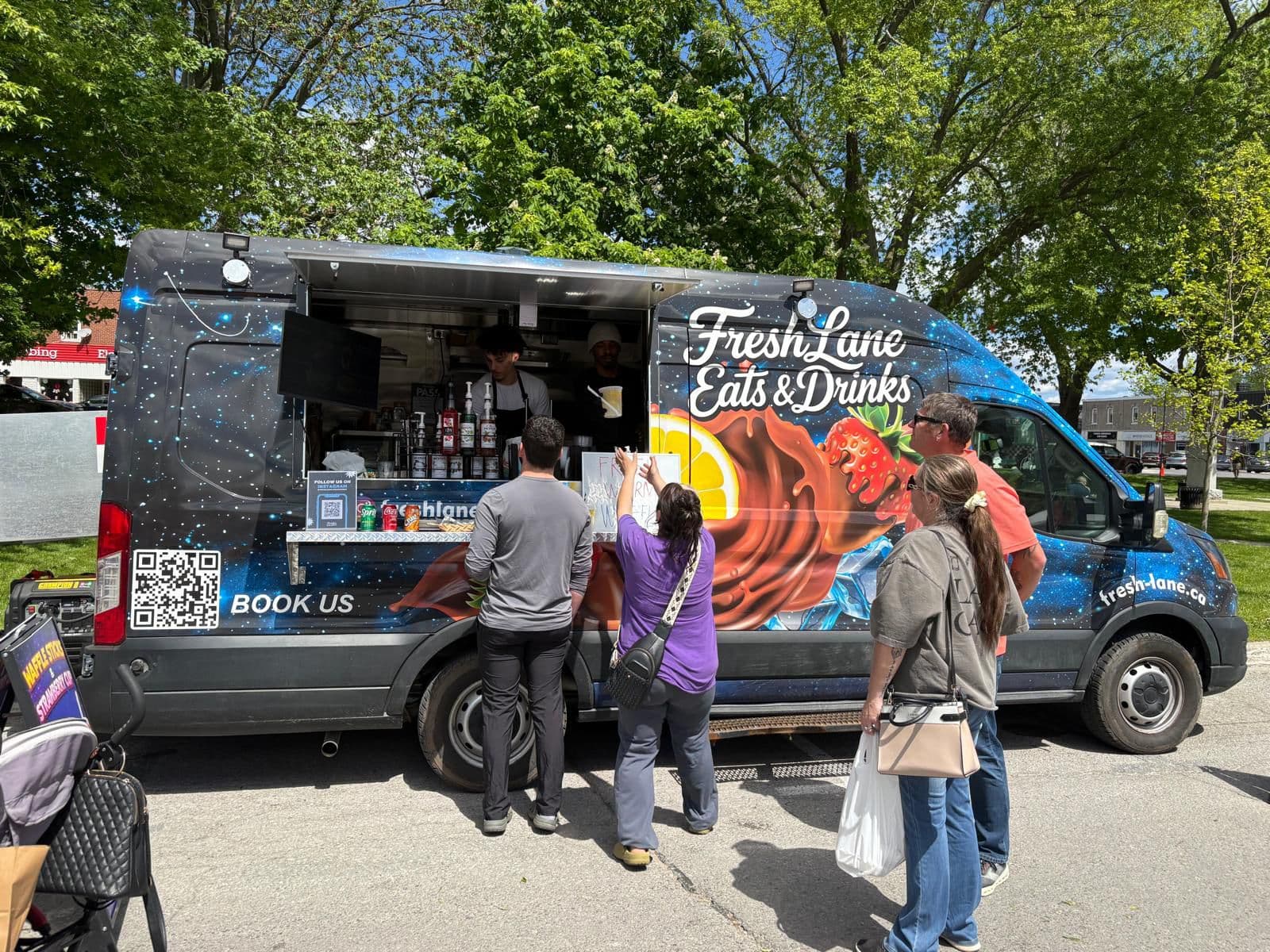 The FreshLane Eats & Drinks food truck serving guests at an event